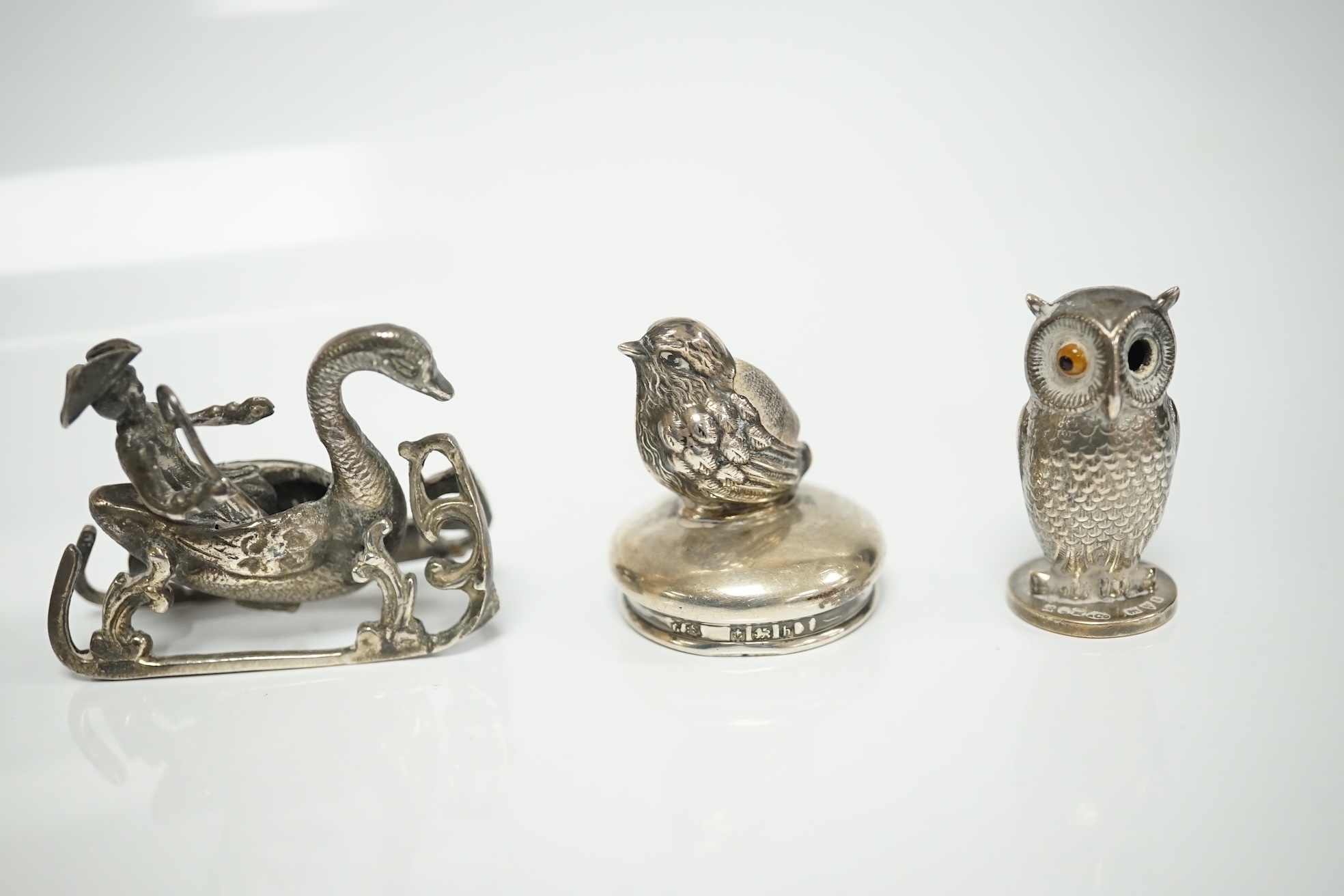 A collection of miniature silver and white metal figures and groups etc. including a swan sleigh, import marks for Chester, 1900, 41mm. Condition - poor to fair